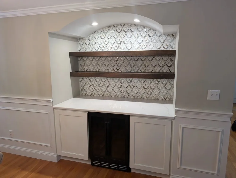 White built-in cabinetry with tile backsplash and wine cooler
